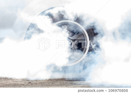 Close up car wheel with smoke on the asphalt road speed track, Car wheel drifting and smoking on track, Car wheel spinning. Close up car wheel with smoke on the asphalt road speed track, Car wheel drifting and smoking on track, Car wheel spinning. 106970808
