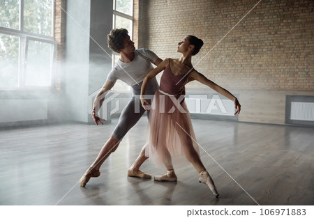 Beautiful young ballet dancers performing choreographic art 106971883
