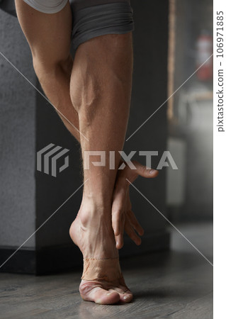Professional athletic male artist foot and arm closeup 106971885