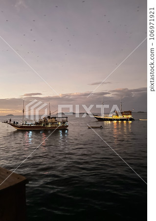 Two yachts at sea at sunset closeup 106971921