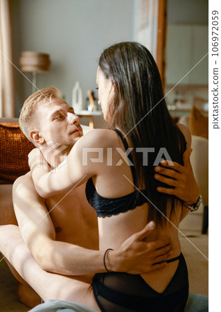 Attractive romantic woman in seductive lingerie flirting with man 106972059