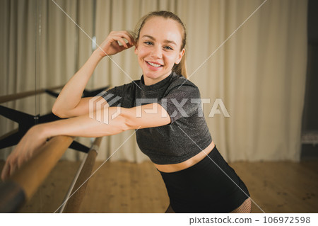 Active young woman portrait female ballet or contemporary dance teacher class in studio - copy space and empty place for text Active young woman portrait female ballet or contemporary dance teacher class in studio - copy space and empty place for text 106972598