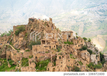 Dagestan Gamsutl. Ancient ghost town of Gamsutl old stone houses in abandoned Gamsutl mountain village in Dagestan, Abandoned etnic aul, summer landscape. 106972800