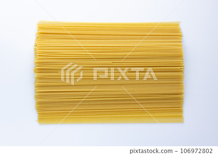 Bright yellow spaghetti on a white background laid out horizontally Pasta is a popular dish and an ingredient for a healthy diet. Bright yellow spaghetti on a white background laid out horizontally Pasta is a popular dish and an ingredient for a healthy diet. 106972802