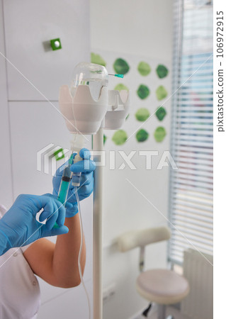 A swab is pressed onto the injection site during the blood collection. A swab is pressed onto the injection site during the blood collection. 106972915