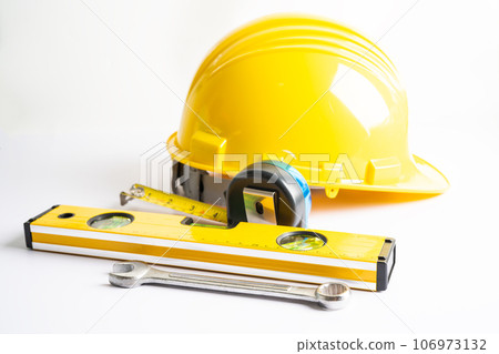 Architectural house plan project blueprint and yellow helmet with calculator, engineer construction tools. Architectural house plan project blueprint and yellow helmet with calculator, engineer construction tools. 106973132
