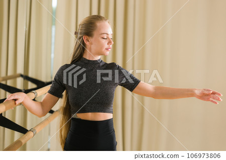 Ballerina in pointe pose. Beautiful ballet dancer stretching in class. Ballerina woman training 106973806