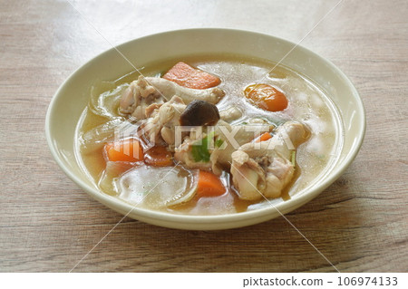 boiled braised chicken drumstick with carrot and tomato couple onion topping mushroom soup on plate boiled braised chicken drumstick with carrot and tomato couple onion topping mushroom soup on plate 106974133