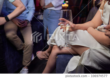 Clinking glasses with alcohol and toasting, party. 106974577