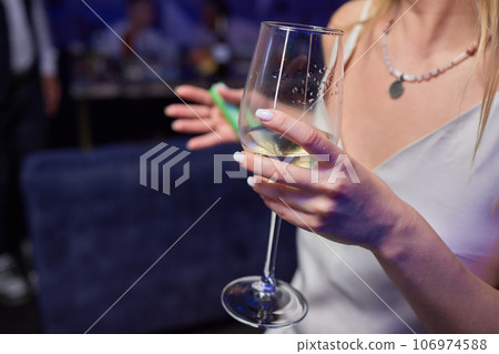 Clinking glasses with alcohol and toasting, party. 106974588