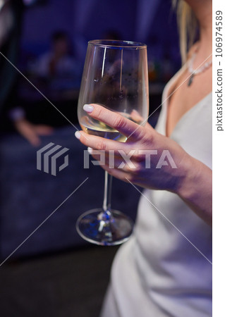 Clinking glasses with alcohol and toasting, party. 106974589