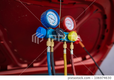 monitor tool on car engine ready to check and fixed car air conditioner system in car garage. 106974630