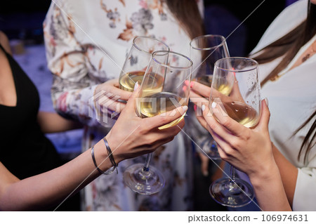 Clinking glasses with alcohol and toasting, party. 106974631