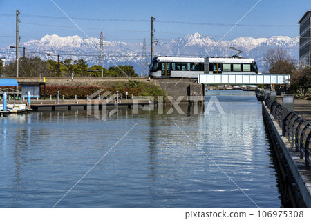 Toyama Local Railway Toyama Port Line tram crossing Iwase Canal 106975308