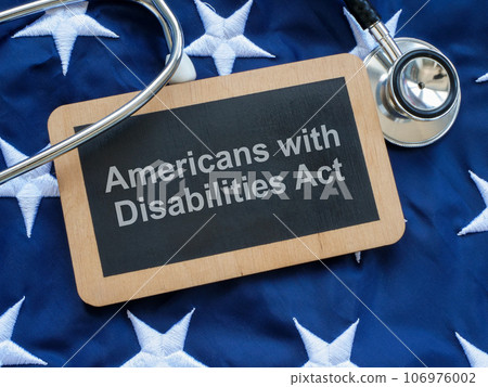 Sign with the inscription Americans with Disabilities Act ADA on the US flag. 106976002