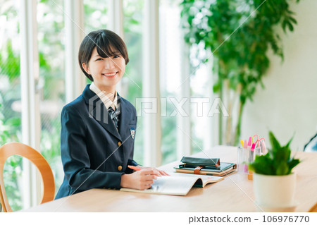 High school girl spreads out materials and smiles High school girl spreads out materials and smiles 106976770