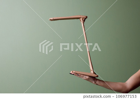 Female hand holds a brand new table lamp wrapped in rustic beige craft paper. Black Friday shopping concept. 106977153