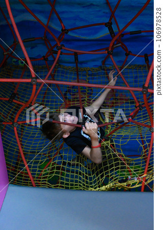 The boy climbs up the labyrinth through the web The boy climbs up the labyrinth through the web 106978528
