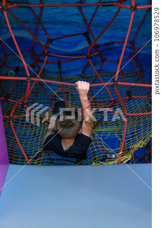 The boy climbs up the labyrinth through the web The boy climbs up the labyrinth through the web 106978529