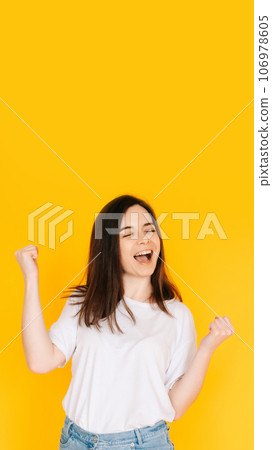 Exultant Woman Celebrating with Fist Raised, Shouting 'Yes' - Victory, Achievement, Success Concept Exultant Woman Celebrating with Fist Raised, Shouting 'Yes' - Victory, Achievement, Success Concept 106978605