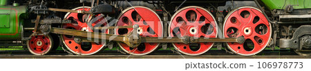 Red wheels of antique steam locomotive 106978773