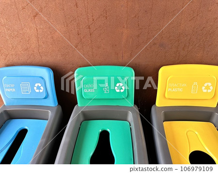 Multicolored plastic trash cans with the inscription paper, glass, plastic for sorting different types of garbage. Plastic bins, garbage cans, recycling. Colored boxes, garbage sorting. Preservation o Multicolored plastic trash cans with the inscription paper, glass, plastic for sorting different types of garbage. Plastic bins, garbage cans, recycling. Colored boxes, garbage sorting. Preservation o 106979109