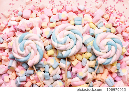 Confectionery and sweeties background: light pink and white marshmallows, sugar confetti, bonbon and candies Confectionery and sweeties background: light pink and white marshmallows, sugar confetti, bonbon and candies 106979933