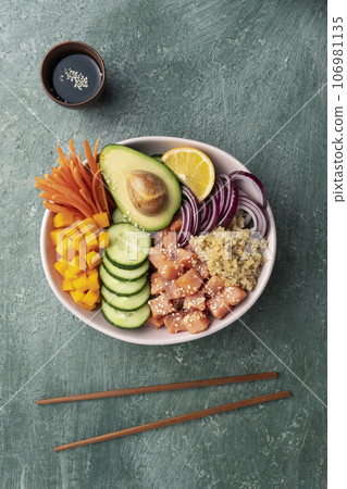 poke bowl salmon with quinoa and vegetables 106981135