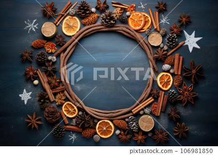Christmas Round Frame from Natural Branches, Tangerines and cinnamon on blue background Christmas Round Frame from Natural Branches, Tangerines and cinnamon on blue background 106981850