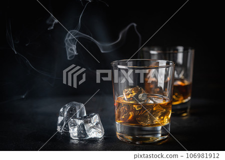 Whiskey with ice in glasses Whiskey with ice in glasses 106981912