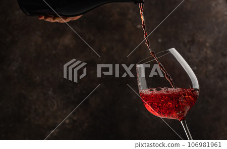 Pouring white wine Pouring white wine 106981961