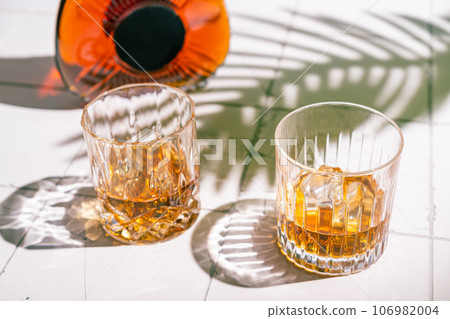 Whiskey with ice in glasses Whiskey with ice in glasses 106982004