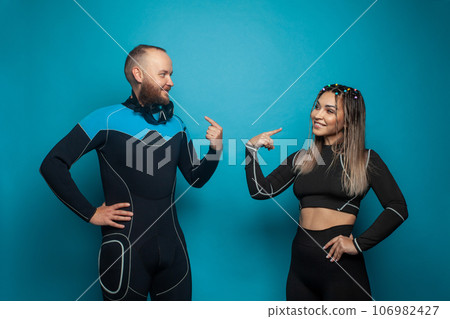 Two fit people on blue background. Happy man and woman portrait Two fit people on blue background. Happy man and woman portrait 106982427