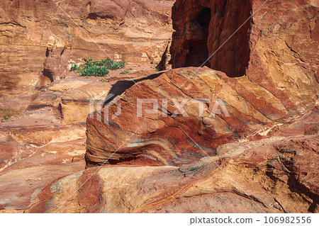 Close-up view of the sandstone rocks during the day in the Siq Gorge, Petra, Jordan Close-up view of the sandstone rocks during the day in the Siq Gorge, Petra, Jordan 106982556