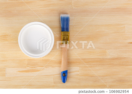white paint with a brush on a wooden background with texture 106982954