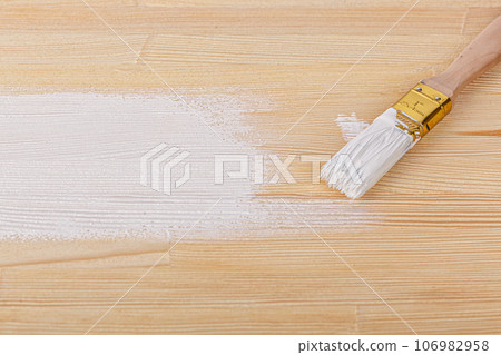 white paint with a brush on a wooden background with texture white paint with a brush on a wooden background with texture 106982958