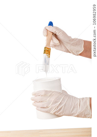 white paint with a brush painting a wooden background with texture 106982959