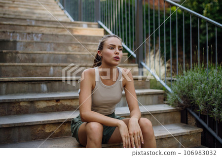 Beautiful diabetic woman feeling dizzy after running workout in the city. 106983032