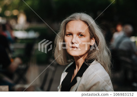 Portrait of beautiful smiling woman in middle age with gray hair. Portrait of beautiful smiling woman in middle age with gray hair. 106983152