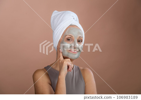 Portrait of happy senior woman with face-mask, selfcare and skin routine concept. Portrait of happy senior woman with face-mask, selfcare and skin routine concept. 106983189