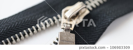 Metal zipper on white background, selected focus. Metal zipper on white background, selected focus. 106983309