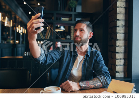 Man looking into the camera while making a selfie 106983315