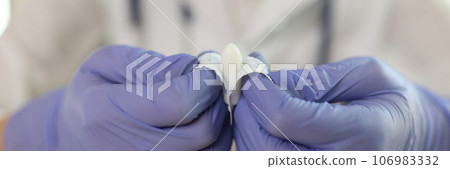 Gynecologist shows suppositories for anal or vaginal use close up. Gynecologist shows suppositories for anal or vaginal use close up. 106983332