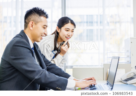 Business person talking with colleague in office Business person talking with colleague in office 106983543