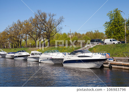 Pleasure motor boats are moored in Saint-Petersburg on a sunny day Pleasure motor boats are moored in Saint-Petersburg on a sunny day 106983796
