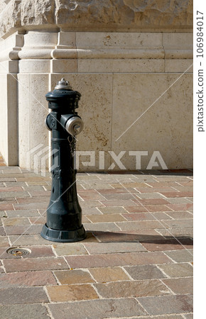 An ordinary hydrant on the stone road 106984017