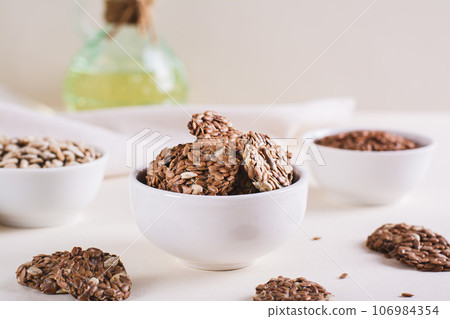 Crispy baked bread from flax and sunflower seeds in a bowl on the table Crispy baked bread from flax and sunflower seeds in a bowl on the table 106984354