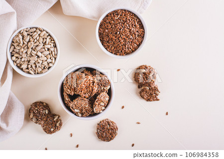 Crispy baked bread from flax and sunflower seeds in a bowl on the table top view 106984358