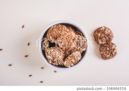 Close up of crispy baked bread from flax and sunflower seeds in a bowl on the table top view Close up of crispy baked bread from flax and sunflower seeds in a bowl on the table top view 106984359