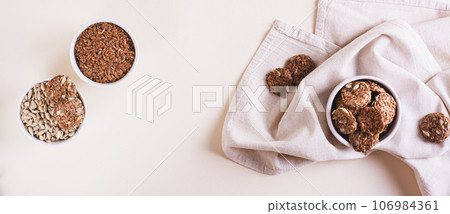 Homemade crispbread made from flax and sunflower seeds in a bowl on the table top view web banner Homemade crispbread made from flax and sunflower seeds in a bowl on the table top view web banner 106984361
